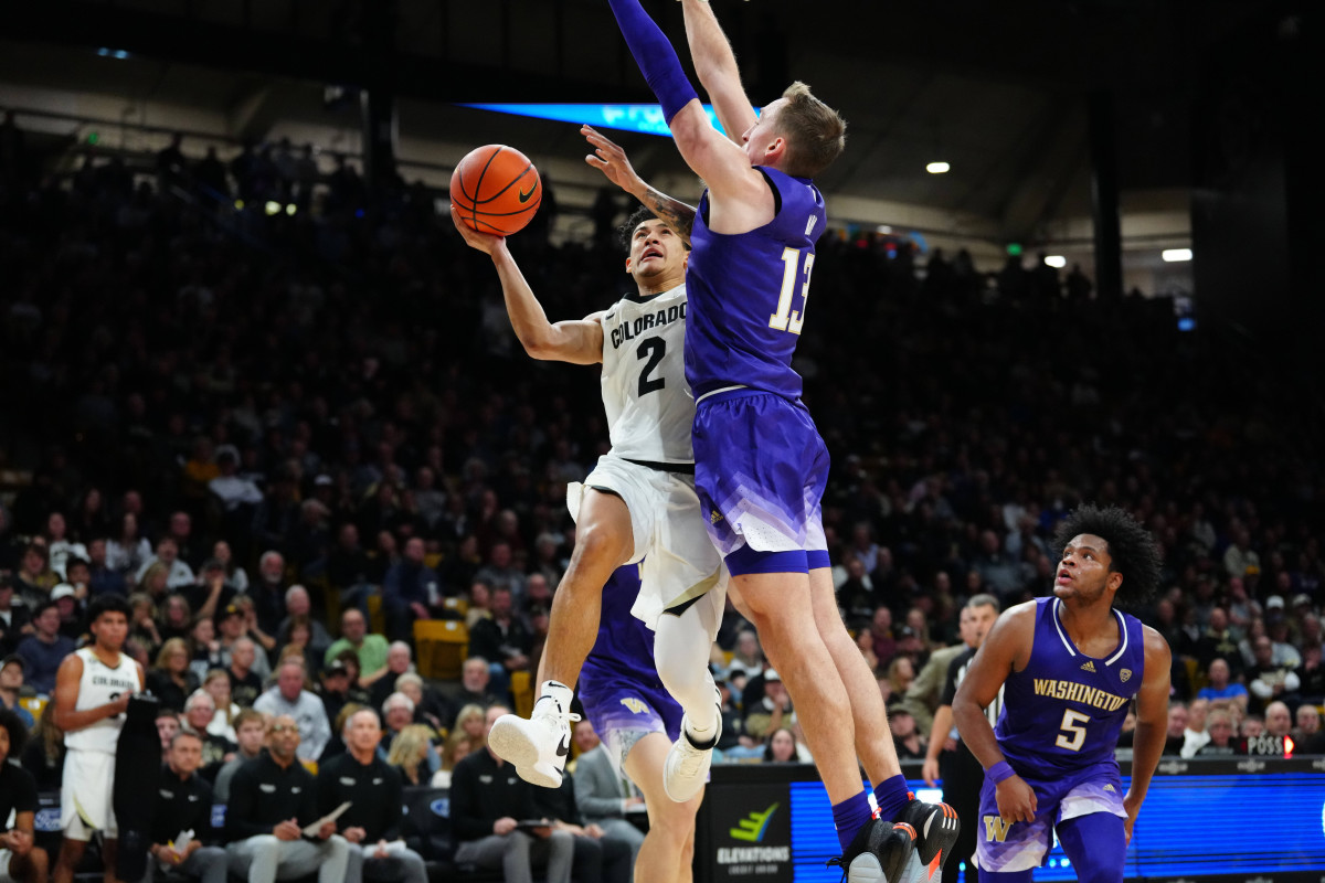 Dec 29, 2023; Boulder, Colorado, USA; Colorado Buffaloes guard KJ Simpson (2) shoots the ball past Washington Huskies forward Moses Wood (13) in the second half at the CU Events Center